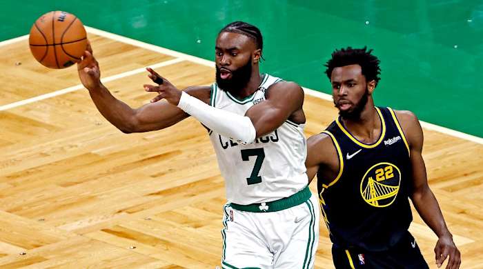 Jun 8, 2022; Boston, Massachusetts, USA; Boston Celtics guard Jaylen Brown (7) passes the ball against Golden State Warriors forward Andrew Wiggins (22) in game three of the 2022 NBA Finals at TD Garden.